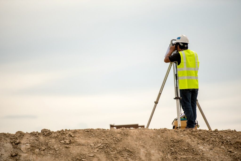 Surveyor on a hill